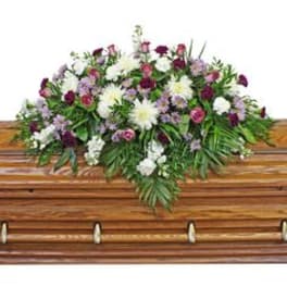 Casket spray with white and purple flowers