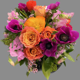 Bouquet of orange and purple flowers in a black vase