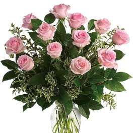 Pink roses arranged in a clear glass vase
