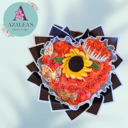 Orange rose bouquet with a sunflower center, butterflies, and a tiara