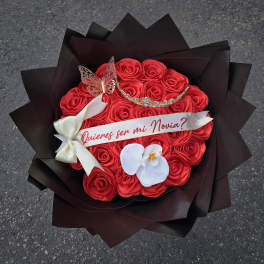 Red rose bouquet with a ribbon and white orchid accent