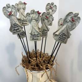 Angel figurines with cardinal accents in a white container