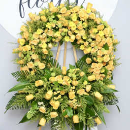 Large yellow floral wreath on a standing easel