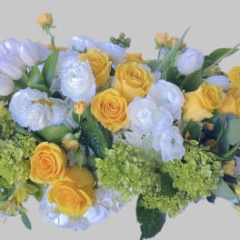 Yellow and white floral arrangement with roses and tulips