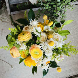 Bouquet of yellow and white flowers with green foliage