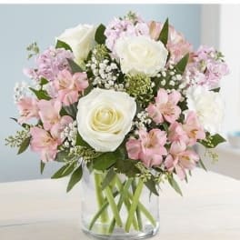 Pink and white bouquet in a clear glass vase