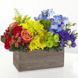 Colorful mixed flower arrangement in a rectangular wooden box