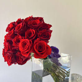 Bouquet of red roses in a clear rectangular vase