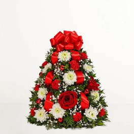 Triangular floral arrangement with red bows, red roses, and white daisies