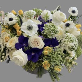 Mixed bouquet with white, yellow, purple, and green flowers