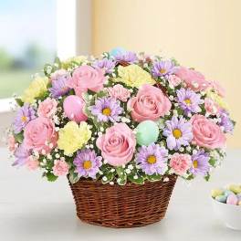 Basket of pink roses, purple daisies, and pastel carnations