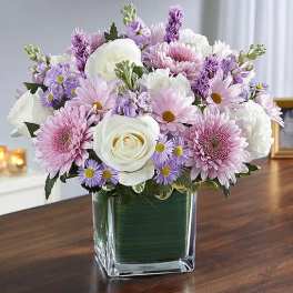 Pink and white mixed bouquet in a square glass vase