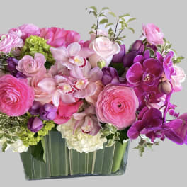 Pink and purple floral arrangement in a glass vase