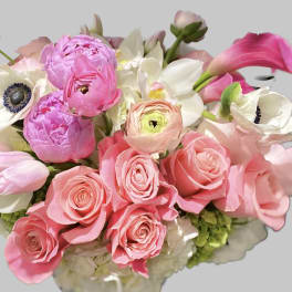 Pink roses and white anemones with calla lilies in a bouquet