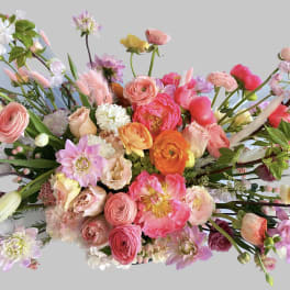 Large mixed bouquet of pink, peach, orange, and white flowers