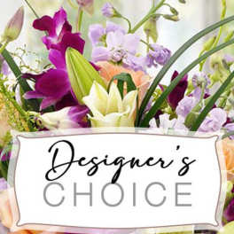 Mixed bouquet of purple, white, and peach flowers with a Designer's Choice sign