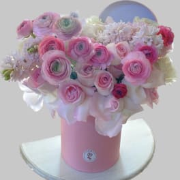 Pink and white bouquet in a pink cylindrical box