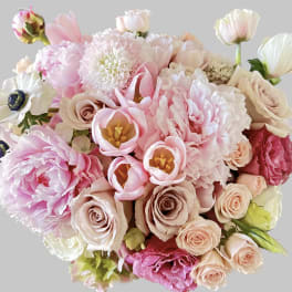 Bouquet of pink and cream flowers with roses and tulip-like blooms