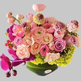 Pink and peach mixed bouquet in a green vase