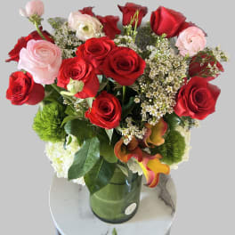 Bouquet of red and pale pink roses in a glass vase