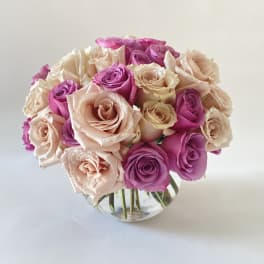 Bouquet of pink and blush roses in a clear glass vase