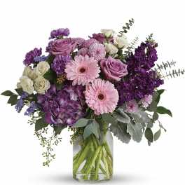 Pink and purple mixed bouquet in a clear glass vase
