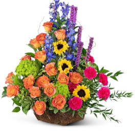 Colorful mixed flower arrangement in a woven basket