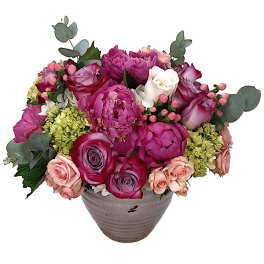 Pink and purple rose bouquet in a gray vase