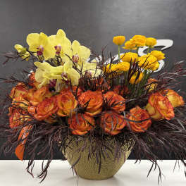 Orange roses and yellow orchids in a woven basket