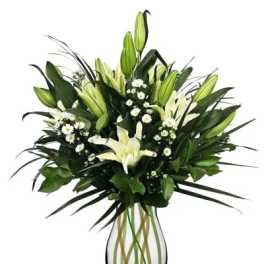White lilies and small white daisies in a clear glass vase