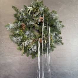Evergreen wreath with pinecones and hanging white bead strands