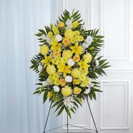 Yellow and white standing floral spray on an easel