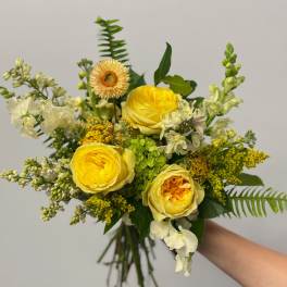 Yellow rose bouquet with white accent flowers and greenery