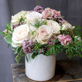 Cream and blush roses arranged in a white vase