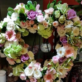 Heart-shaped floral wreath with pastel roses and gerbera daisies