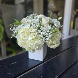White hydrangea and rose bouquet in a white vase