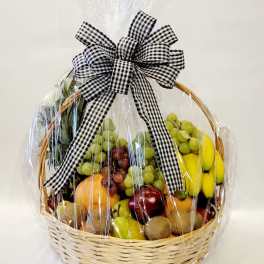 Fruit basket wrapped in clear cellophane with a black-and-white bow