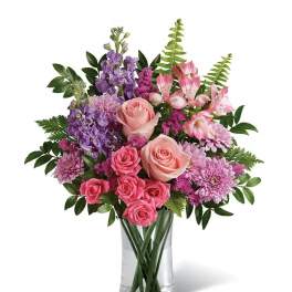 Pink and purple mixed bouquet in a clear glass vase