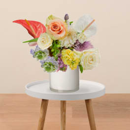 Mixed bouquet in a white vase with roses and anthuriums
