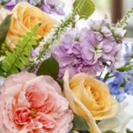 Pastel bouquet with pink, yellow, purple, and blue flowers