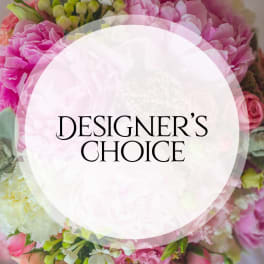 Pink and white floral arrangement with a Designer's Choice label