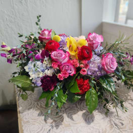 Mixed bouquet of pink, red, yellow, and lavender flowers
