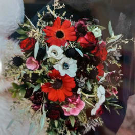Bouquet of red, white, and pink flowers with dark foliage