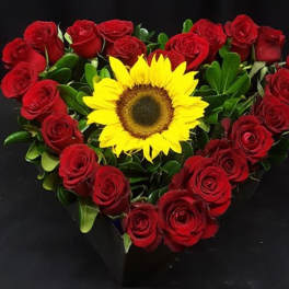 Heart-shaped bouquet of red roses with a yellow sunflower center