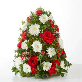 Cone-shaped floral arrangement with red roses, white daisies, and pinecones