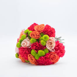 Hand-tied bouquet of orange and blush roses, red carnations, and green button mums