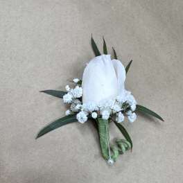 White boutonniere with small white flowers and green leaves