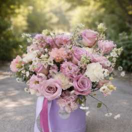 Pink and white rose bouquet in a lavender hat box with ribbon