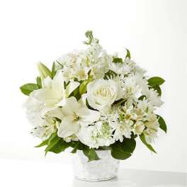 White flowers arranged in a white basket vase