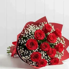 Bouquet of red roses with white baby's breath wrapped in red paper